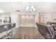 Open living area with an accent wall, wood floors, kitchen access and modern lighting at 6618 Latherton Ln, Charlotte, NC 28278
