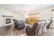 Spacious living room featuring a stone fireplace, hardwood floors, and comfortable seating near bright windows at 6618 Latherton Ln, Charlotte, NC 28278