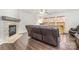 Comfortable living room with a stone fireplace, hardwood floors, and three leather recliners arranged for relaxation at 6618 Latherton Ln, Charlotte, NC 28278