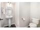 Modern powder room featuring a pedestal sink and neutral décor at 6618 Latherton Ln, Charlotte, NC 28278