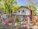 View of the home's backyard featuring a deck, garden, and exterior structures with brick and siding at 6820 Elm Forest Dr, Charlotte, NC 28212