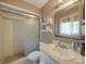 Bathroom featuring a shower with glass doors, a vanity, and a large mirror at 6820 Elm Forest Dr, Charlotte, NC 28212