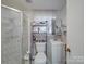 Bathroom features a shower with glass doors, toilet, and small sink at 6820 Elm Forest Dr, Charlotte, NC 28212
