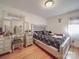 Bedroom features a silver bed frame, mirrored vanity, and hardwood floors at 6820 Elm Forest Dr, Charlotte, NC 28212