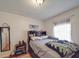 Bedroom features a queen bed, hardwood floors, and a window with sheer curtains at 6820 Elm Forest Dr, Charlotte, NC 28212