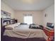 Bedroom features a queen bed, hardwood floors, and a computer desk at 6820 Elm Forest Dr, Charlotte, NC 28212