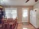 Bright dining area with a wooden table, natural light, and direct access to the kitchen at 6820 Elm Forest Dr, Charlotte, NC 28212