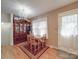 Cozy dining room with wood table set, decorative china cabinet, and a chandelier at 6820 Elm Forest Dr, Charlotte, NC 28212