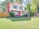 Attractive home with a well-maintained lawn, inviting entrance, and vibrant landscaping at 6820 Elm Forest Dr, Charlotte, NC 28212