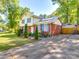 Charming exterior of a two-story home with brick and siding, complemented by well-kept landscaping and a driveway at 6820 Elm Forest Dr, Charlotte, NC 28212
