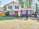 Charming two-story home with a manicured lawn and colorful flower beds enhancing its curb appeal at 6820 Elm Forest Dr, Charlotte, NC 28212