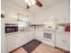 A bright kitchen features white cabinetry and appliances, with a subway tile backsplash at 6820 Elm Forest Dr, Charlotte, NC 28212