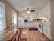 Bright kitchen featuring white appliances, ample cabinet space, and wood-look flooring at 6820 Elm Forest Dr, Charlotte, NC 28212
