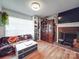 Bright living room featuring a brick fireplace, custom shelving, and a cozy sofa at 6820 Elm Forest Dr, Charlotte, NC 28212