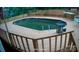 Backyard view of the above-ground pool with wooden deck surrounding it with railings and table at 6820 Elm Forest Dr, Charlotte, NC 28212