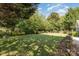 A well-manicured lawn surrounded by lush trees provides a private and serene outdoor space at 6941 Augustine Way, Charlotte, NC 28270