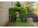 Landscaped backyard featuring a charming archway entrance and lush greenery at 6941 Augustine Way, Charlotte, NC 28270