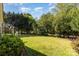 Spacious backyard with lush lawn and mature trees providing plenty of shade at 6941 Augustine Way, Charlotte, NC 28270