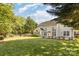 Enjoy this spacious backyard featuring a large patio, well-maintained lawn, and mature trees at 6941 Augustine Way, Charlotte, NC 28270