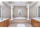 Luxurious bathroom showcasing a tiled tub with columns at 6941 Augustine Way, Charlotte, NC 28270