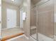 Bright bathroom features a glass enclosed shower with a built in bench and neutral color scheme at 6941 Augustine Way, Charlotte, NC 28270
