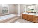 Elegant primary bathroom with soaking tub, columns, and double vanities at 6941 Augustine Way, Charlotte, NC 28270