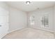 Neutral bedroom featuring natural light and a doorway at 6941 Augustine Way, Charlotte, NC 28270