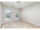 Neutral bedroom with two windows providing natural light and plush carpeting at 6941 Augustine Way, Charlotte, NC 28270