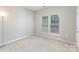 Well-lit bedroom featuring a large window at 6941 Augustine Way, Charlotte, NC 28270