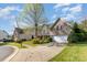 Charming brick home featuring a manicured lawn, inviting driveway, and attached two car garage at 6941 Augustine Way, Charlotte, NC 28270