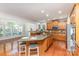 Gourmet kitchen featuring granite countertops, stainless steel appliances, and a large island with seating at 6941 Augustine Way, Charlotte, NC 28270
