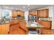 Spacious kitchen boasts granite counters, stainless steel appliances, and a large island at 6941 Augustine Way, Charlotte, NC 28270