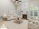 Bright living room featuring a fireplace, soaring ceilings, and arched windows providing ample natural light at 6941 Augustine Way, Charlotte, NC 28270