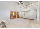 Expansive living area featuring a fireplace, soaring ceilings, and an open view of the kitchen and staircase at 6941 Augustine Way, Charlotte, NC 28270