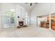 Open-concept living room with high ceilings, a stone fireplace, and a seamless transition to the kitchen at 6941 Augustine Way, Charlotte, NC 28270
