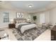 Cozy main bedroom showcasing a tray ceiling, plush bedding, stylish furniture, and ample natural light at 6941 Augustine Way, Charlotte, NC 28270