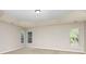 Spacious main bedroom featuring a tray ceiling, carpet, and natural light from windows at 6941 Augustine Way, Charlotte, NC 28270