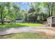 Large backyard with detached garage, patio area, and well-maintained lawn and landscaping at 7020 Leesburg Rd, Charlotte, NC 28215