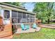 Charming backyard patio with seating area, wood storage, and lush greenery at 7020 Leesburg Rd, Charlotte, NC 28215