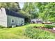 A spacious, green backyard with a large shed, patio, and lush landscaping at 7020 Leesburg Rd, Charlotte, NC 28215