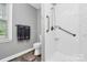 This bathroom features a white toilet and a shower with a chrome shower head at 7020 Leesburg Rd, Charlotte, NC 28215