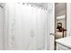 Bathroom showing a white shower curtain, bright white tile, and a glimpse into the bedroom at 7020 Leesburg Rd, Charlotte, NC 28215