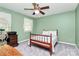 Bedroom featuring a bed with a quilt, a desk with a printer, and a window at 7020 Leesburg Rd, Charlotte, NC 28215