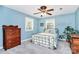 Bedroom with a blue wall, two windows, a bed, and a wooden dresser at 7020 Leesburg Rd, Charlotte, NC 28215