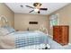 Bedroom featuring a bed with a quilt, a dresser, and a window at 7020 Leesburg Rd, Charlotte, NC 28215