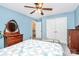Comfortable bedroom with blue walls, a ceiling fan, wood furniture, and ample closet space at 7020 Leesburg Rd, Charlotte, NC 28215