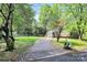 A long driveway leads to a home with a well manicured front lawn at 7020 Leesburg Rd, Charlotte, NC 28215