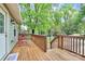 Inviting front porch with wooden railing, seating area, and view of a tree-lined street at 7020 Leesburg Rd, Charlotte, NC 28215