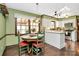 Bright eat-in kitchen featuring hardwood floors, pendant lighting and stainless appliances at 7020 Leesburg Rd, Charlotte, NC 28215