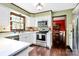 Open kitchen with stainless steel appliances, white countertops, and seamless flow to dining area at 7020 Leesburg Rd, Charlotte, NC 28215